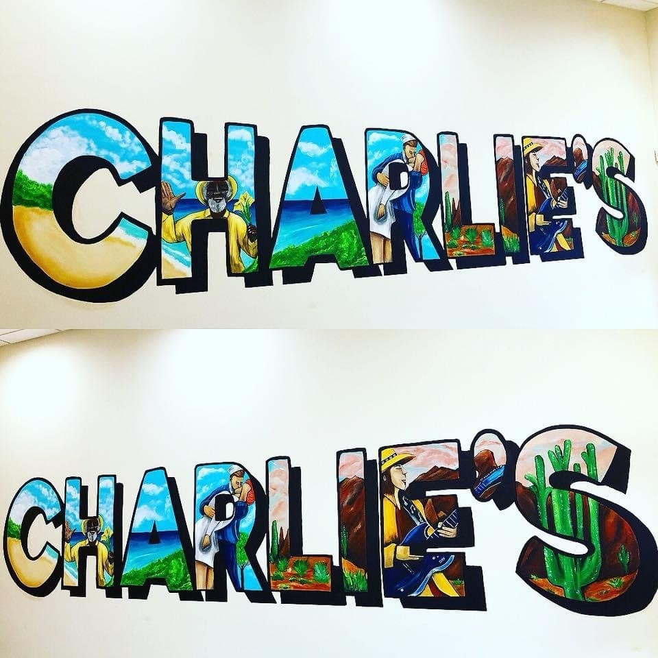 Charlie's hand-painted lettering mural with scenes inside each letter