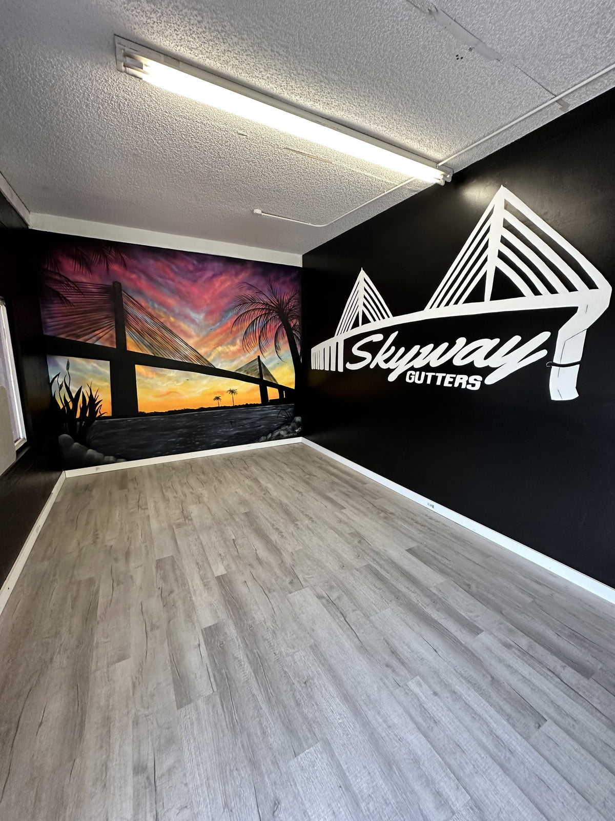 Skyway Gutters custom branding mural in a commercial interior