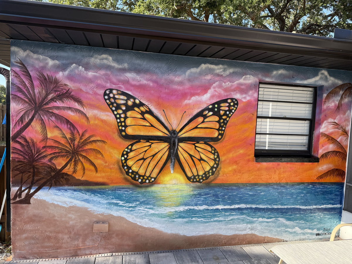 Monarch butterfly over a beach sunset mural