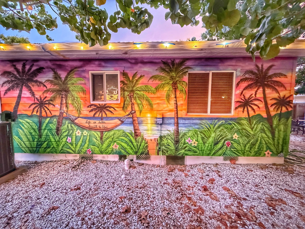 Tropical sunset and palms courtyard mural