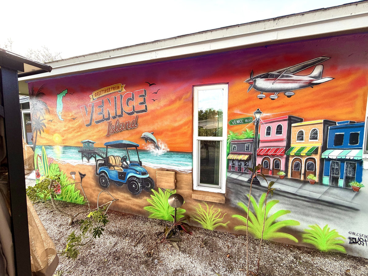 Greetings from Venice Island mural with golf cart, dolphin and storefronts